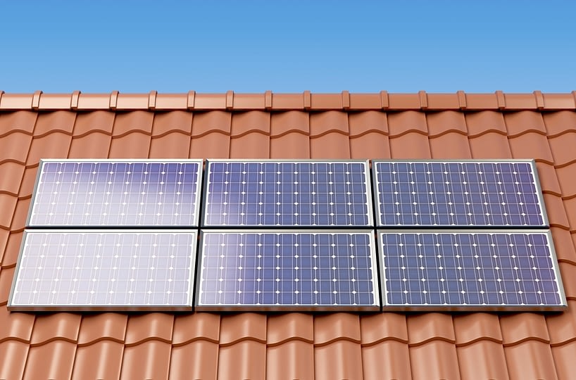 Solar panels on the roof of a house, producing electricity