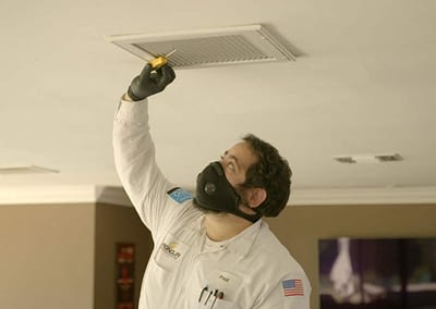 Magnolia technician wearing mask checking air flow