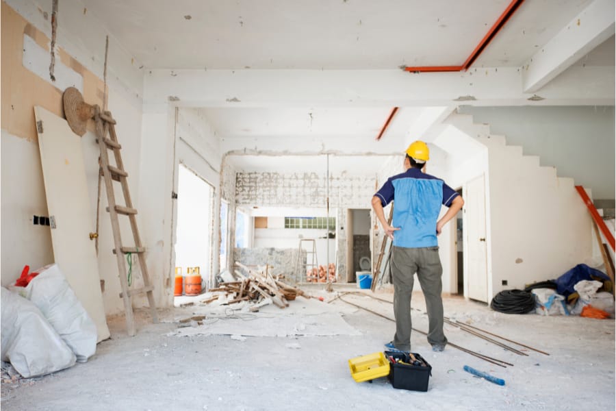 a man standing in a partially renovated house