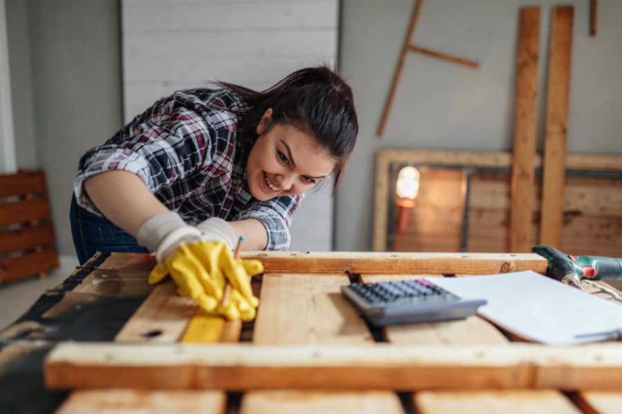 a woman preparing wood before cutting