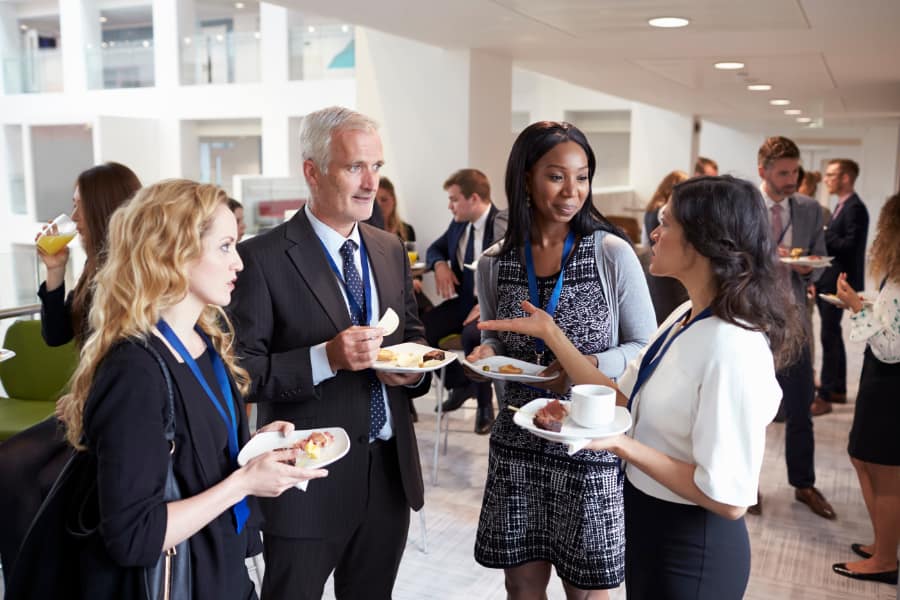 a group of women and men networking indoors