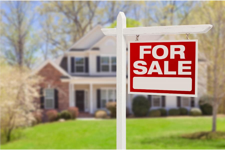 house with for sale board outside