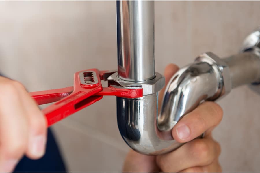 a person fixing pipework