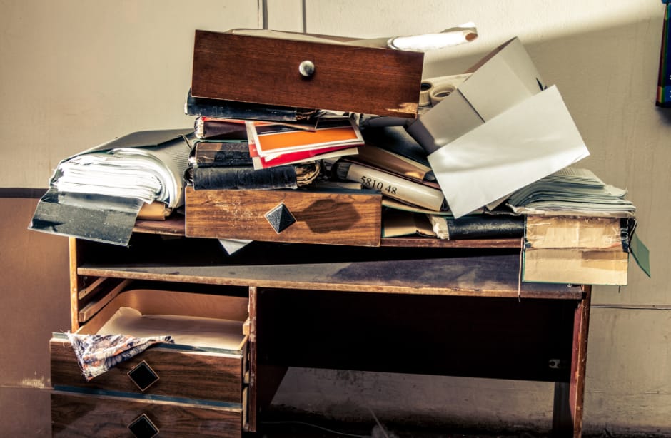 a cluttered desk in a hoarder house