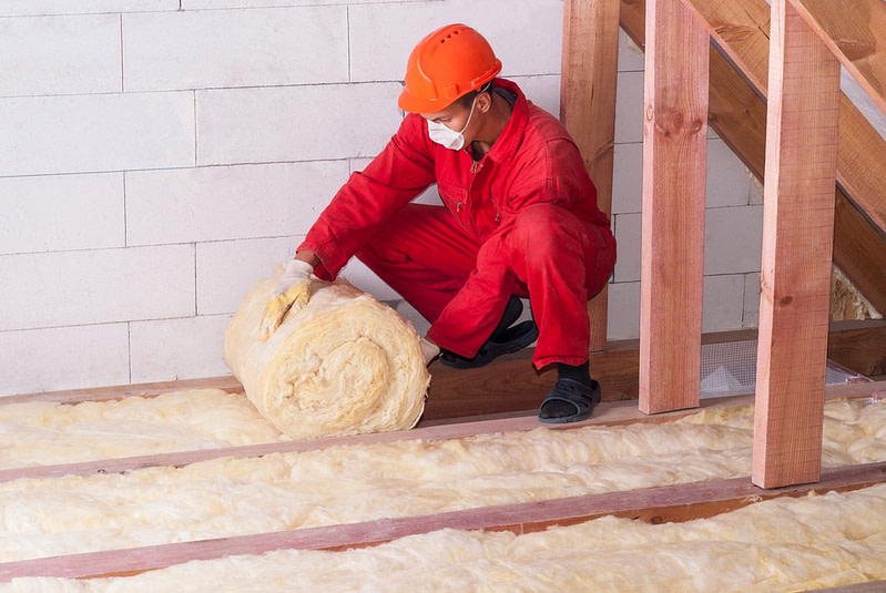 Attic insulation being rolled out in a Riverside, CA home
