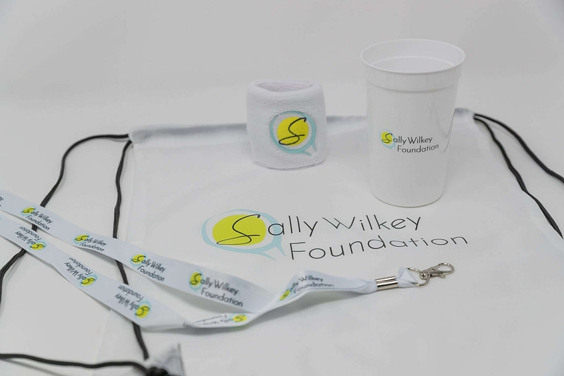 Custom merch packages including lanyards, cups, nylon bags, and sweatbands.