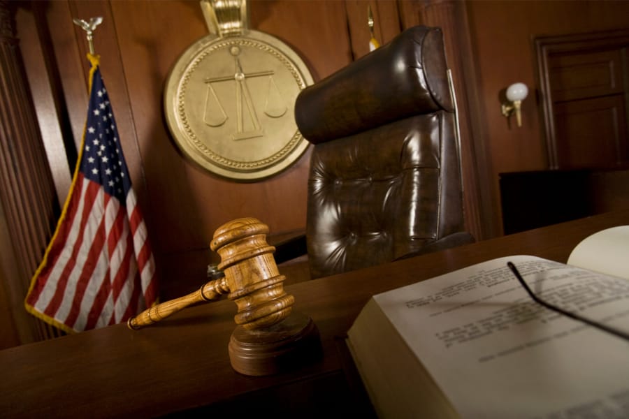 a judges chair in a court room with the american flag hanging up