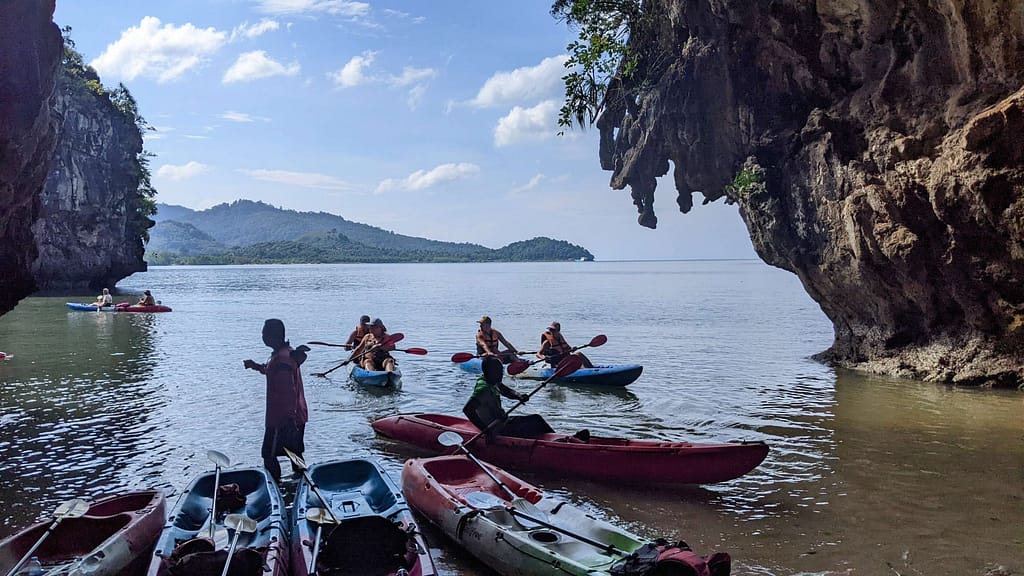 a group of kayaks in a caved bay in krabi