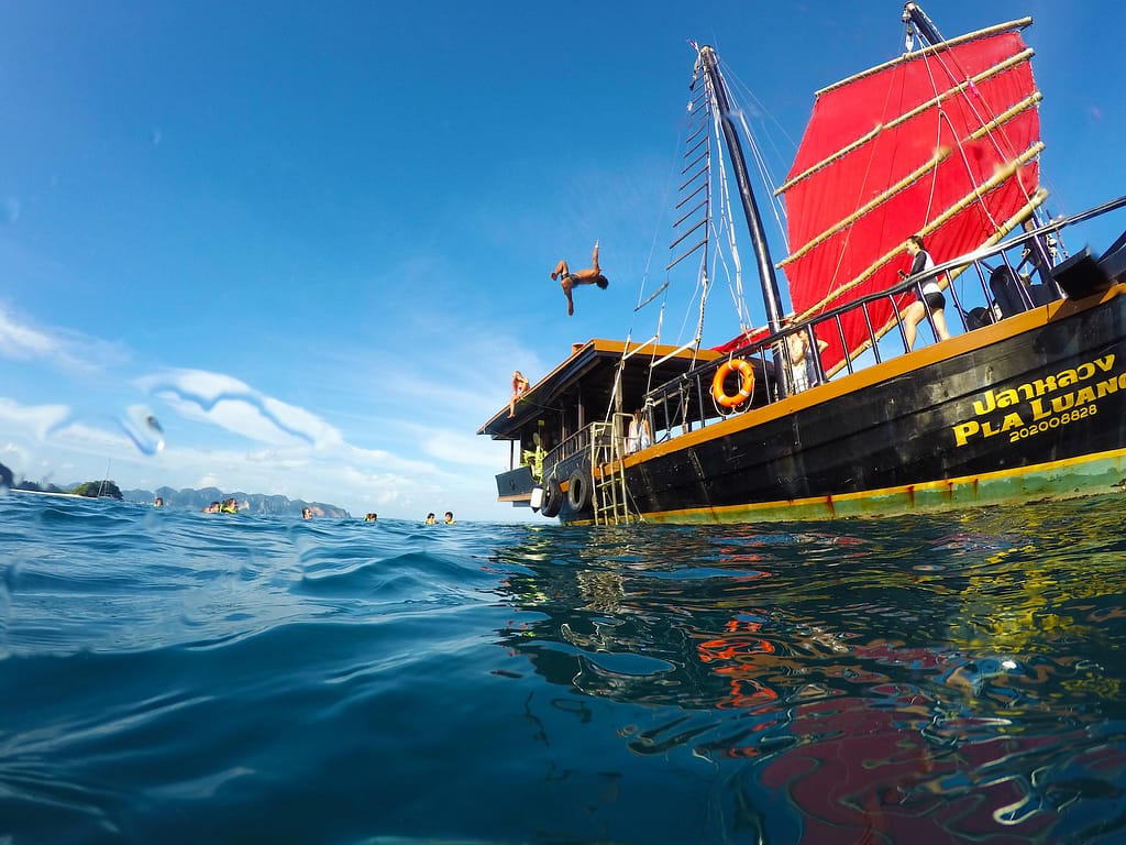 People jumping off Krabi Sunset Cruise boat into sea