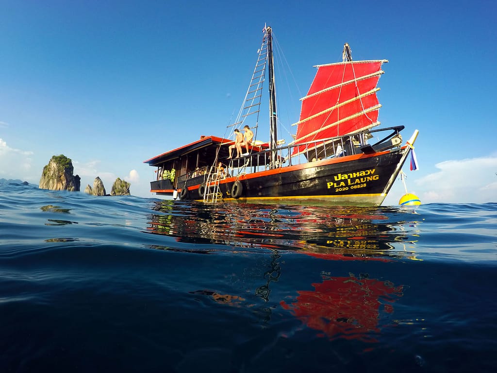 Guests onboard Krabi Sunset Cruise with blue skies and islands in the background