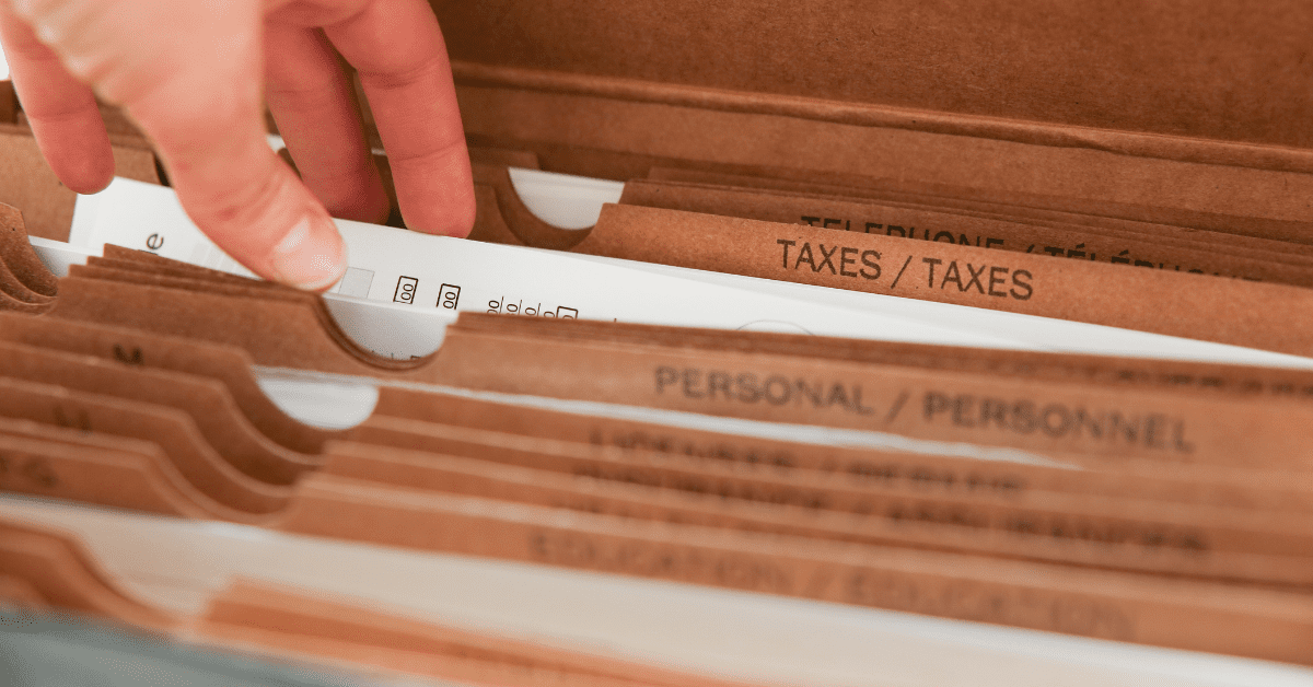 How Do House Cleanouts Work? 5 Tips To Keep in Mind 2 Hand sifting through document folder