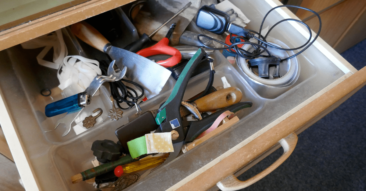 How Do House Cleanouts Work? 5 Tips To Keep in Mind 4 Cabinet drawer with various tools and fixings