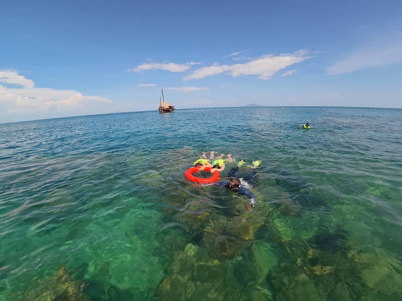 Snorkeling guide accompanying guests over clear tropical water during a private Krabi boat trip.