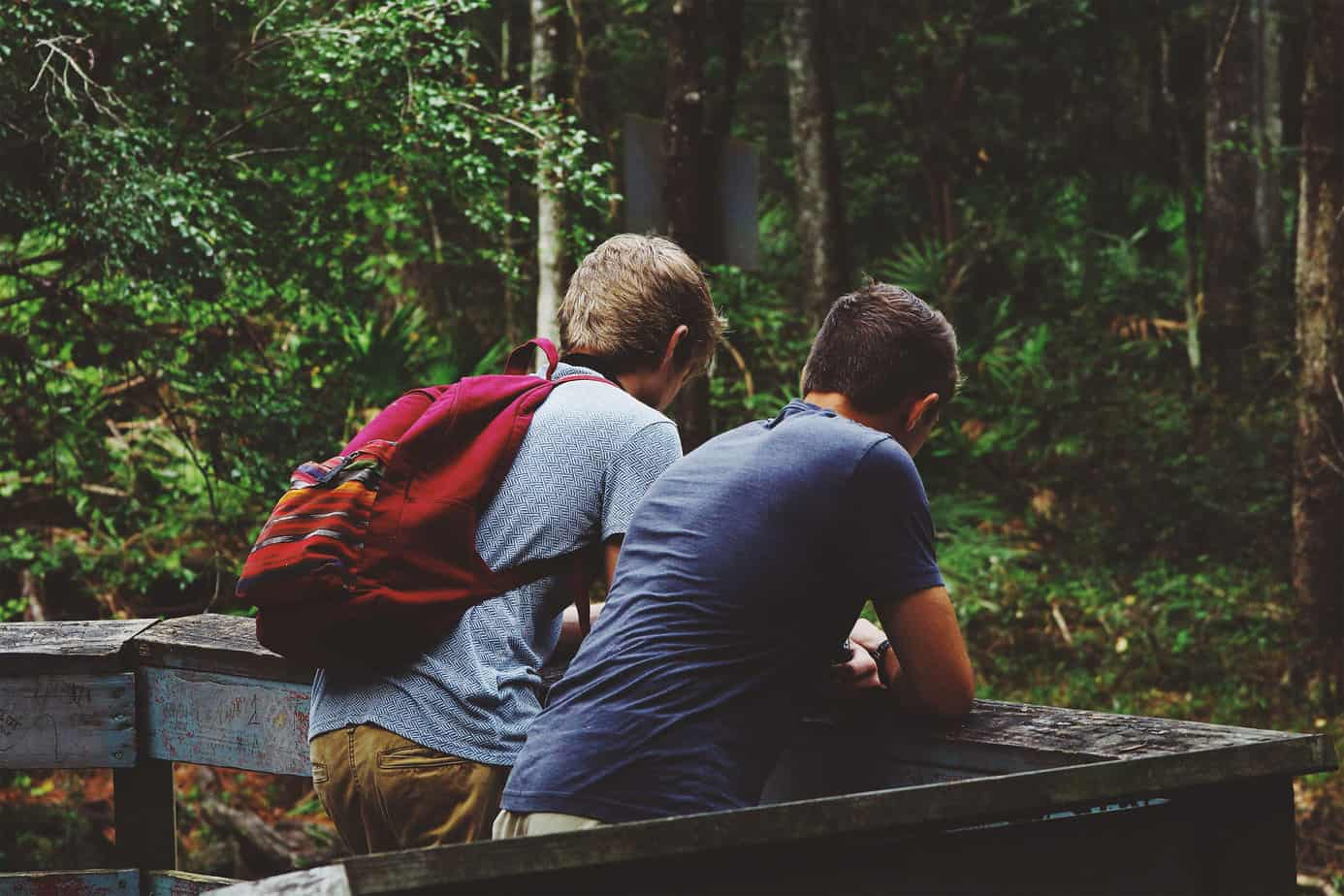 Internet Safety for Kids Two Teen Boys In The Woods Looking At Phones