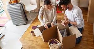 How Do You Move When You Have Too Much Stuff? 1 people packing belongings into cardboard