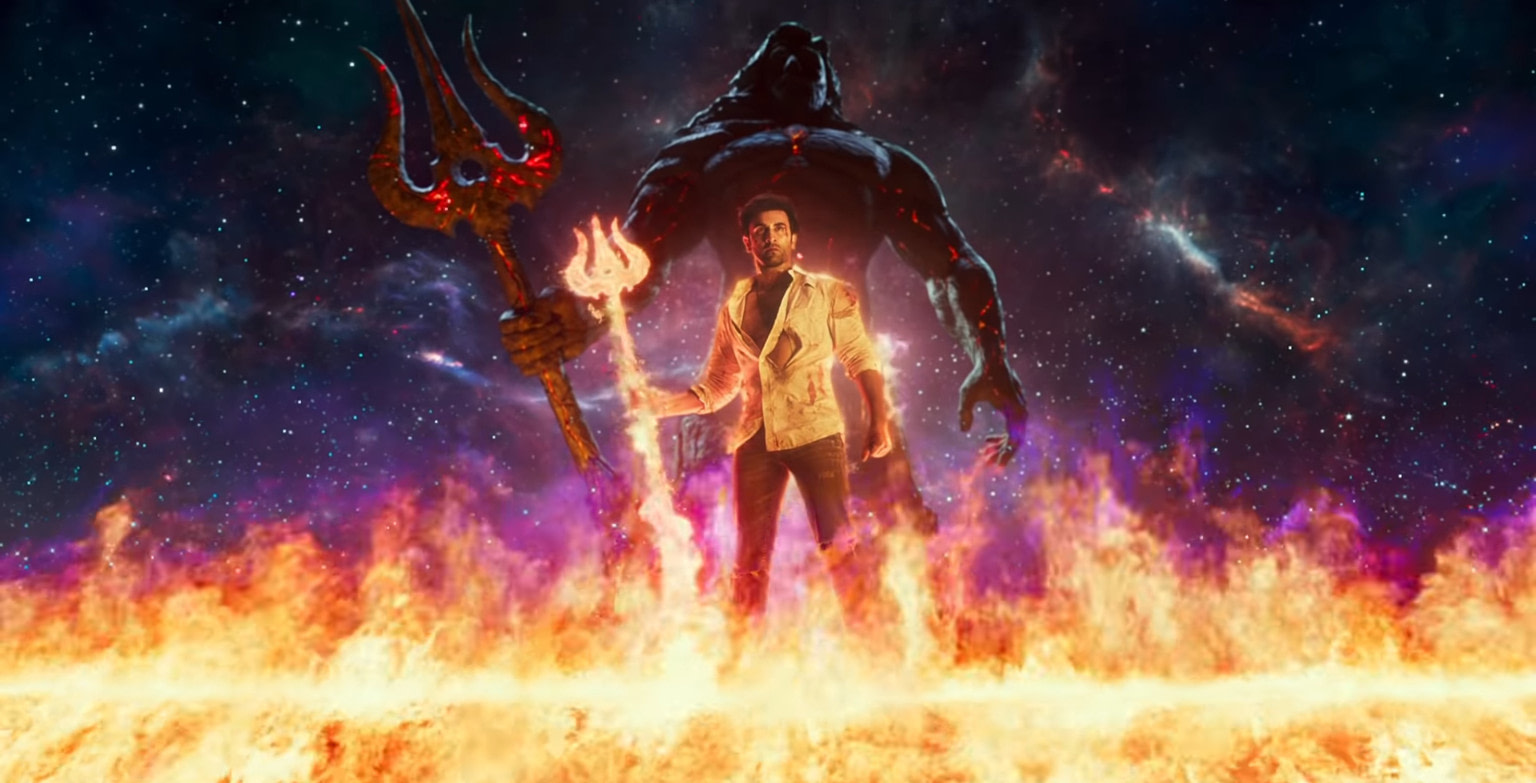A man stands atop a field of flames with a fiery trident in his hand, a giant figure standing behind him in an identical pose against a starry night background.