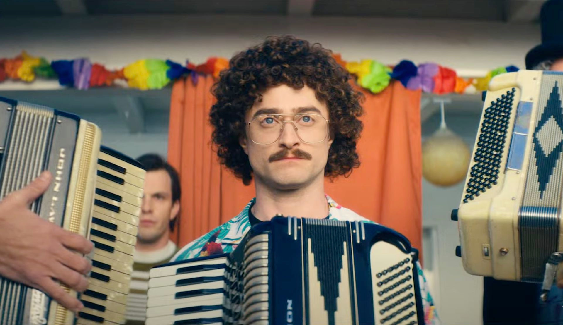 Daniel Radcliffe as Weird Al Yankovic, flanked by accordions, in a still from Weird: The Al Yankovic Story