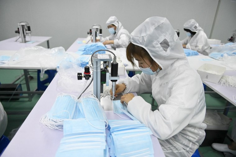 Employees make face masks on a production line at a glove factory, which has started producing face masks as overseas orders for masks at an all time high amid the coronavirus outbreak, on May 16, 2020 in Shenyang, Liaoning Province of China.