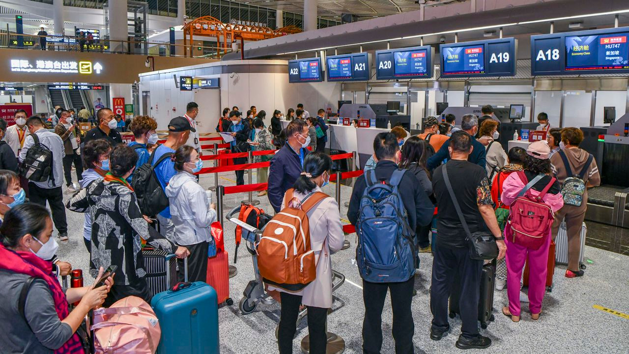 Passengers heading to Singapore checking in at Haikou Airport in China's Hainan province on March 15.