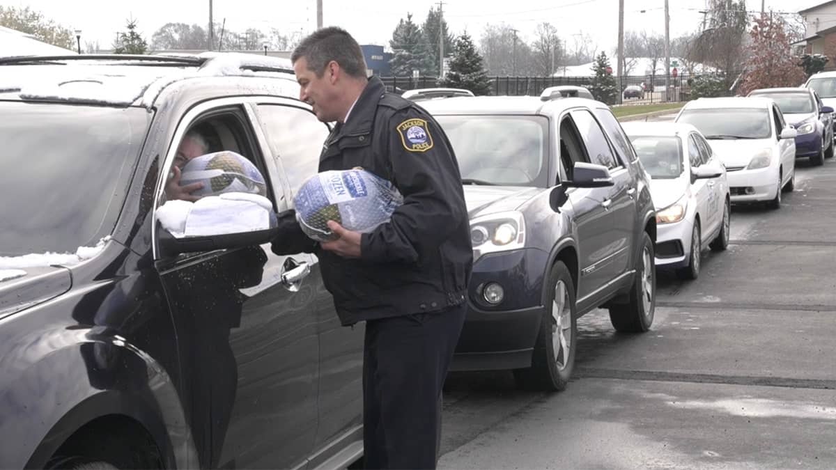 Michigan police hand out turkeys for Thanksgiving to ‘alleviate some financial strain’ amid the holidays