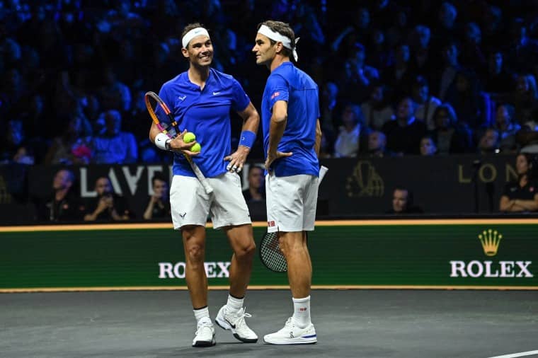 Image: Switzerland's Roger Federer, right, talks with Spain's Rafael Nadal, left, of Team Europe playing against USA's Jack Sock and Frances Tiafoe of Team World during their 2022 Laver Cup men's doubles tennis match at the O2 Arena in London on Sept. 23, 2022.